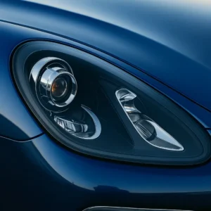 Detailed view of a modern car’s headlamp and surrounding bodywork, emphasizing precision alignment, smooth paint finish, and high-gloss surface treatment.