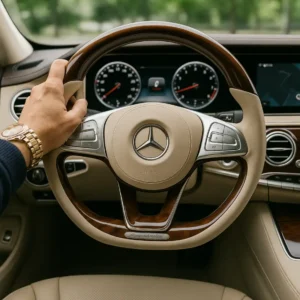 Interior view of a premium car showing the steering wheel, dashboard, and control panel, highlighting the craftsmanship and precision detailing from the driver’s perspective.